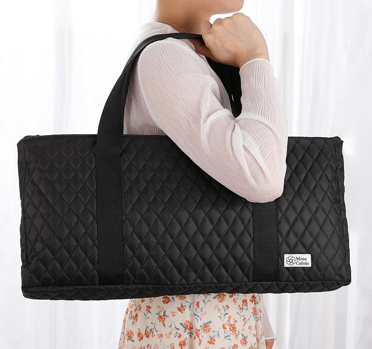 Black quilted bag carried on the shoulder