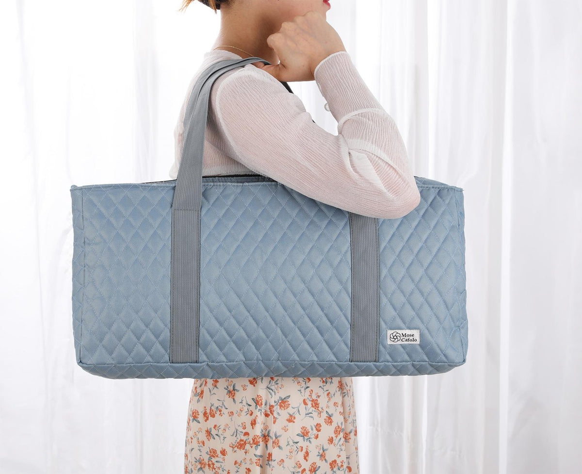 Gray quilted bag carried on the shoulder