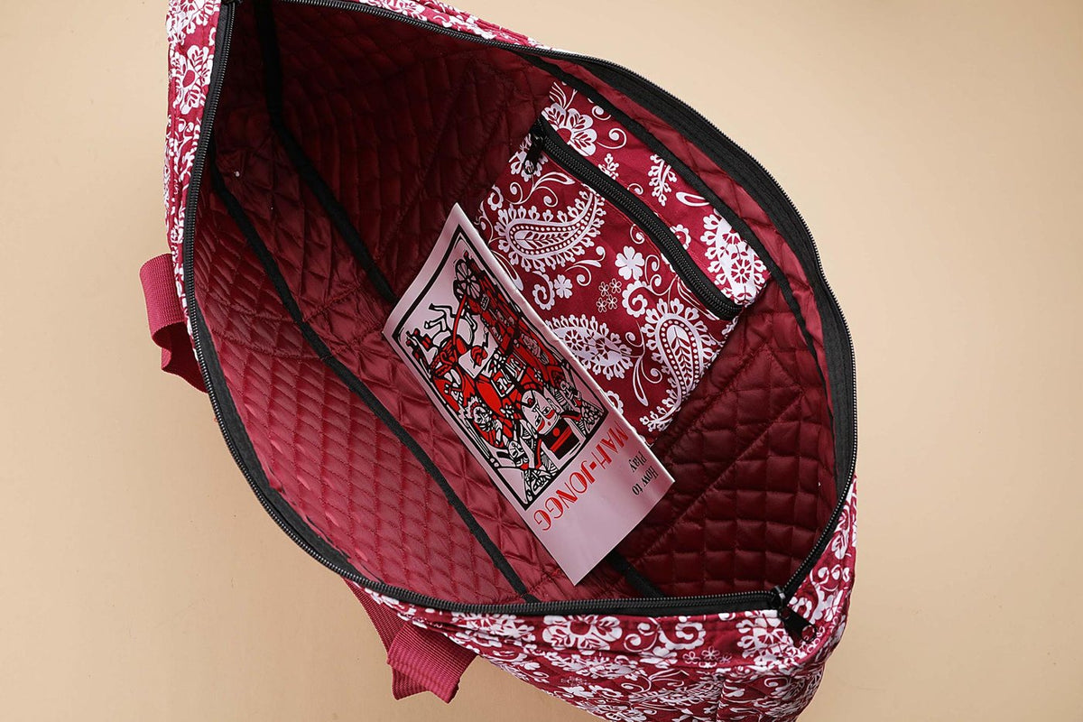 Inside the red paisley bag with zip pocket and booklet