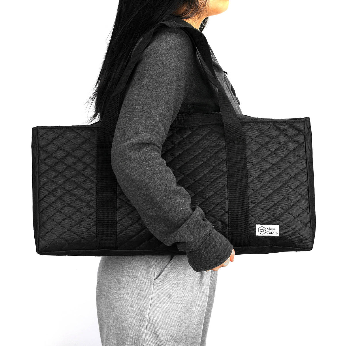 Black quilted mahjong bag carried on the shoulder