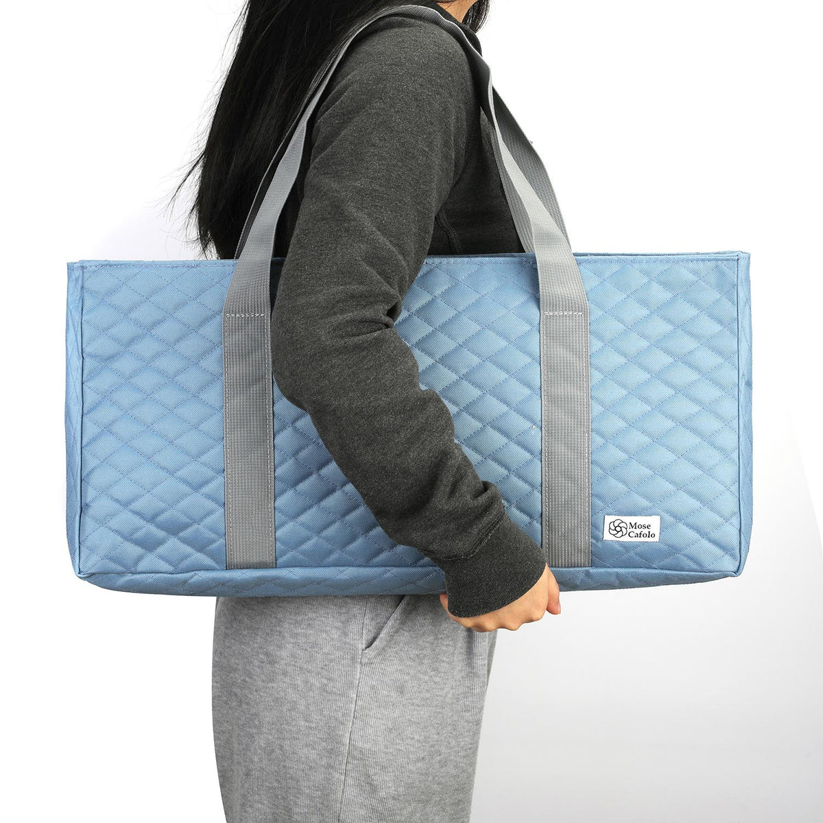 Sky blue quilted mahjong bag carried on the shoulder