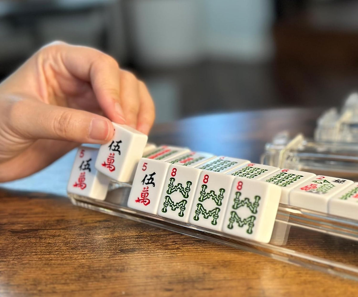 Hand placing a tile on a clear rack