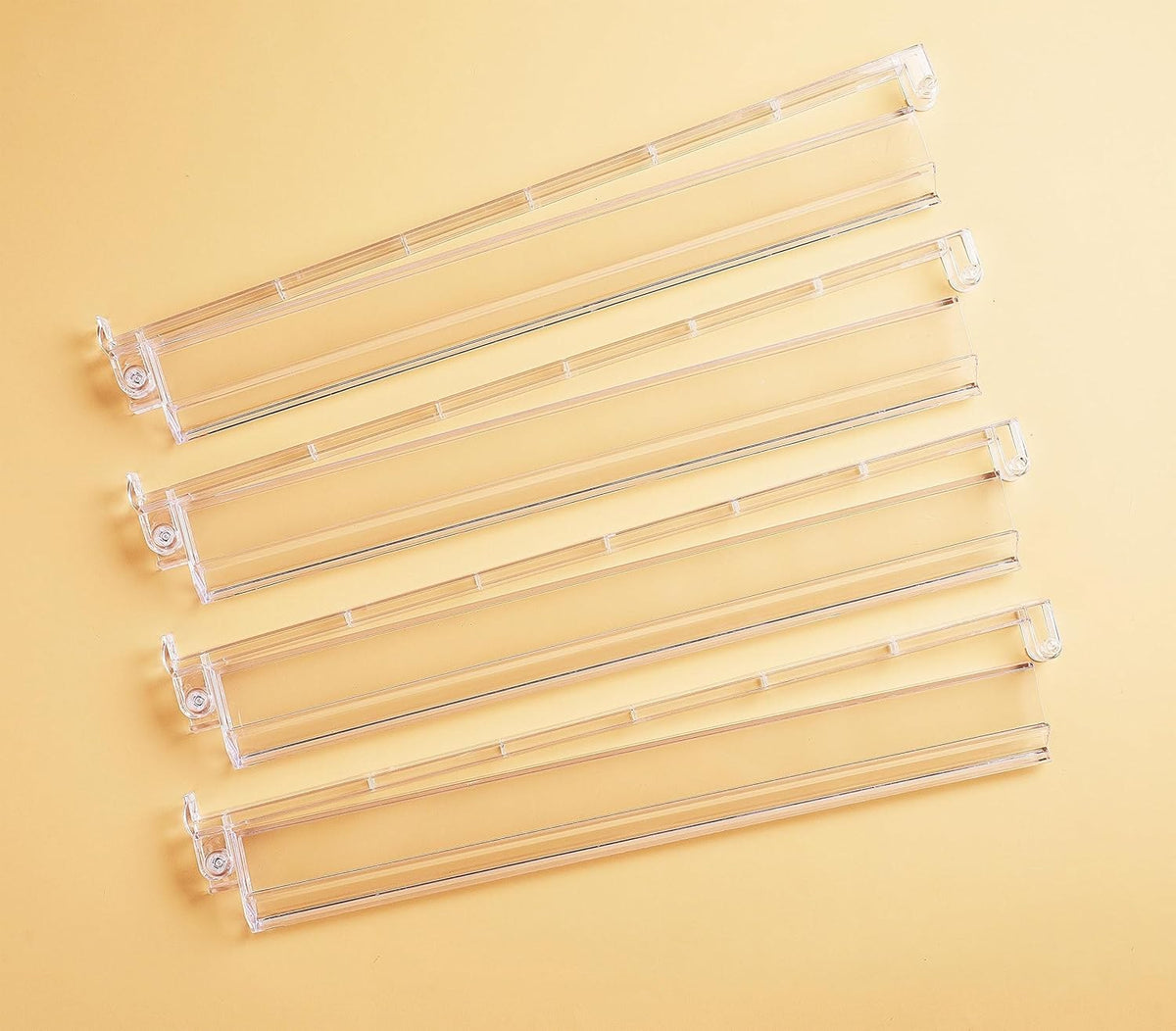 Set of four clear racks laid side by side